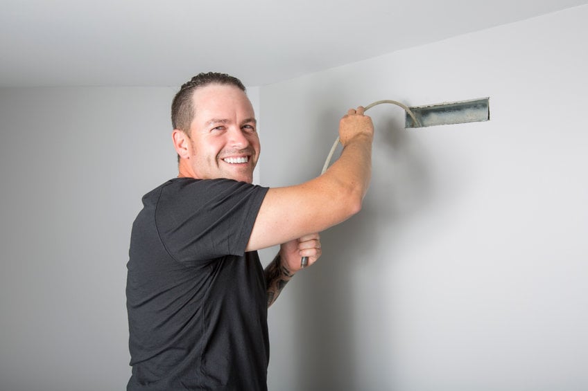 A ventilation cleaner man at work with tool