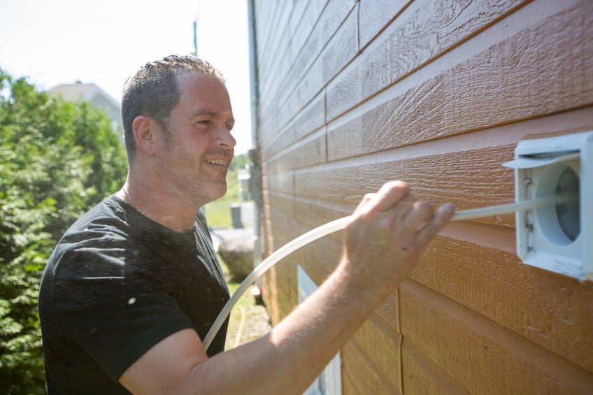 A ventilation cleaner man at work with tool